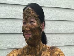 A scat-covered Asian lady smiles